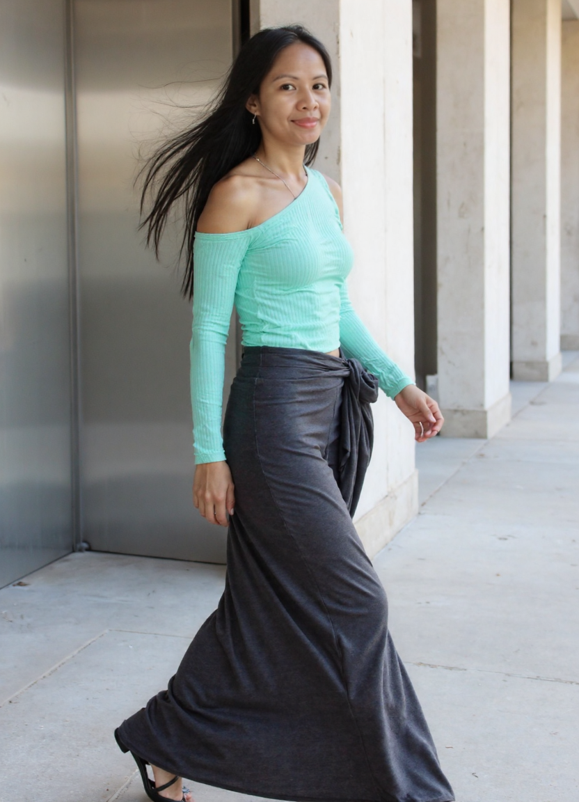 She walks past the elevator, hair caught in motion, glancing back over her shoulder